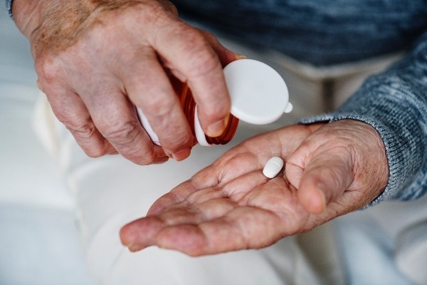 Tipping single tablet out of bottle