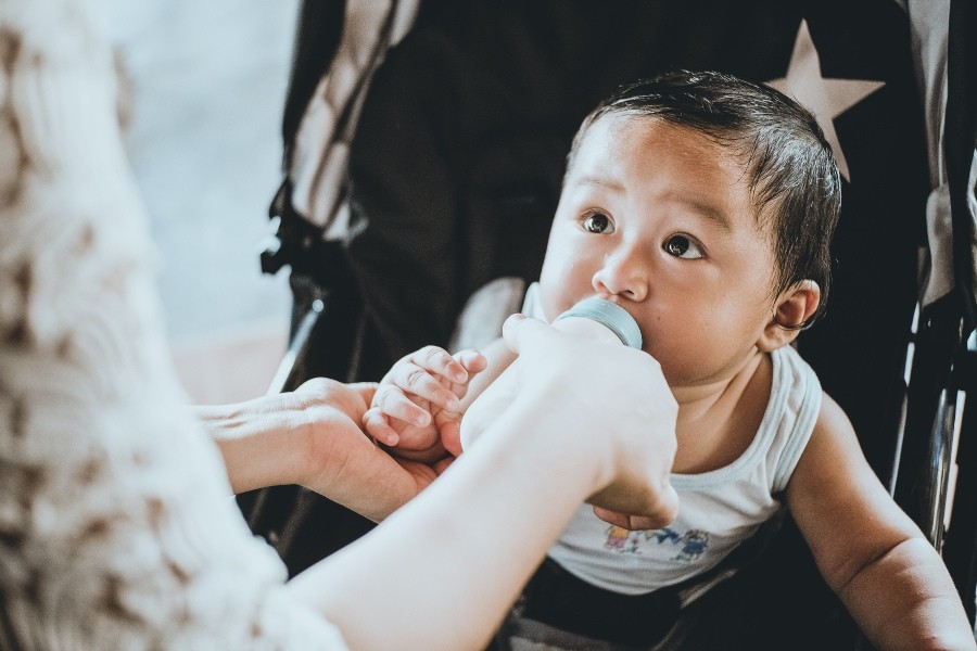 baby feeding from bottle