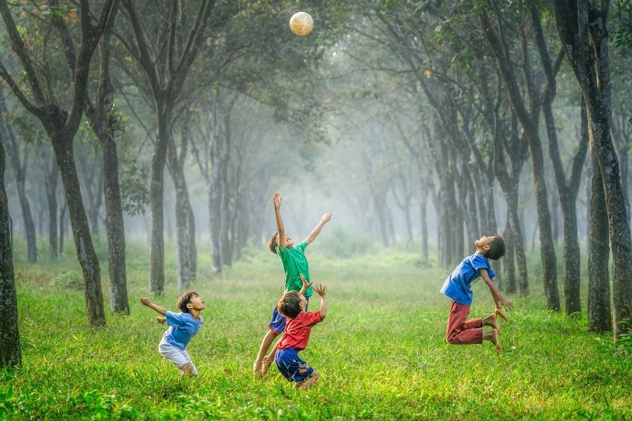 kids playing in field with ball