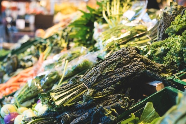 Stand with various leafy dark green vegetables