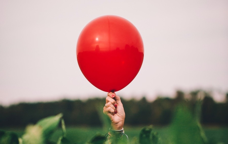 holding a red balloon