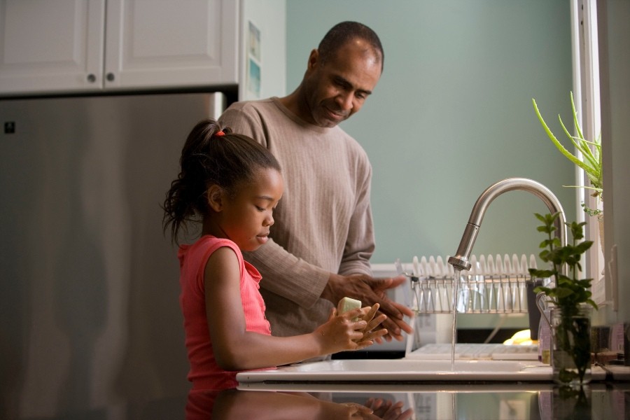 adult and child washing hands